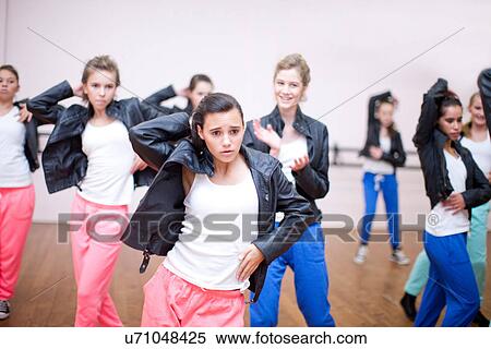 Stock Photography - Group of teenagers practicing dance in studio. Fotosearch