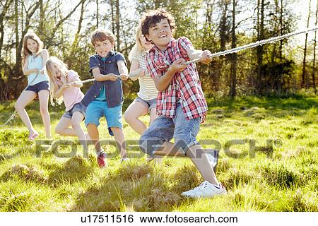 Group of young children playing tug o war View Large Photo Image Stock Photograph - Group of young children playing tug o war. Fotosearch