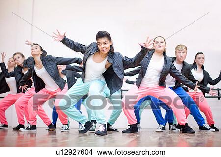 Picture - Large group of teenagers dancing in studio. Fotosearch
