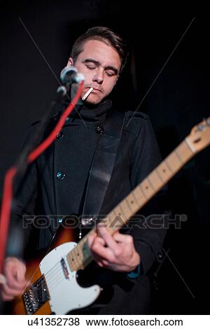Man playing guitar on stage in club View Large Photo Image Stock Photo - Man playing guitar on stage in club. Fotosearch