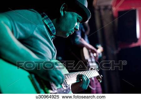 Man playing guitar on stage in nightclub View Large Photo Image Stock Photography - Man playing guitar on stage in nightclub. Fotosearch