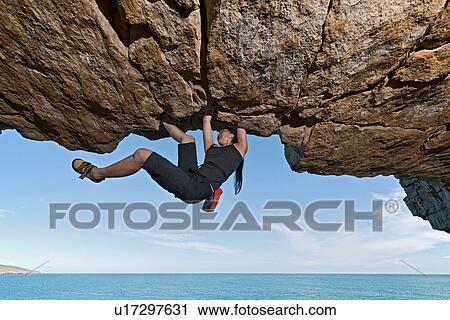 Mature woman rock climbing over ocean View Large Photo Image Stock Image - Mature woman rock climbing over ocean. Fotosearch
