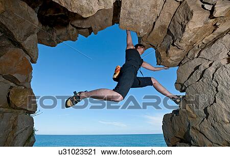 Mature woman rock climbing over ocean View Large Photo Image Stock Image - Mature woman rock climbing over ocean. Fotosearch