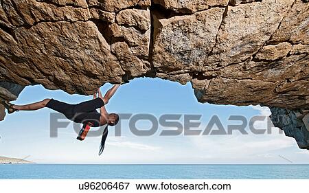 Mature woman rock climbing over ocean View Large Photo Image Stock Photo - Mature woman rock climbing over ocean. Fotosearch