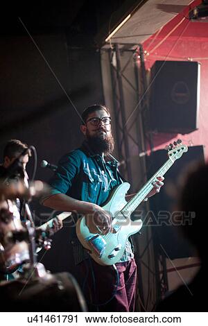 Men playing guitars on stage in club View Large Photo Image Stock Image - Men playing guitars on stage in club. Fotosearch