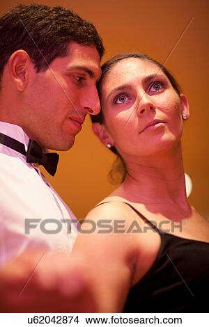 Mid adult woman and young man posing in dance class, close up View Large Photo Image Picture - Mid adult woman and young man posing in dance class, close up. Fotosearch