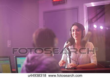 Mid adult woman and young man broadcasting in recording studio View Large Photo Image Stock Photo - Mid adult woman and young man broadcasting in recording studio. Fotosearch