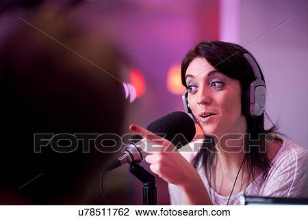 Mid adult woman broadcasting in recording studio View Large Photo Image Stock Image - Mid adult woman broadcasting in recording studio. Fotosearch