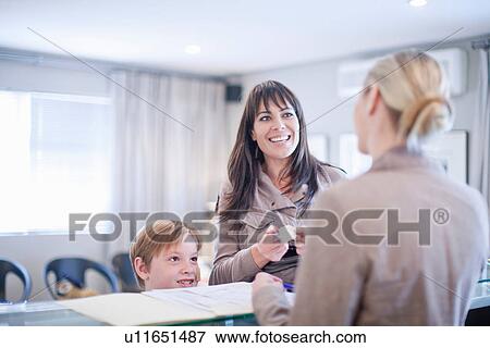 Mother and son making appointment at hospital reception View Large Photo Image Stock Photo - Mother and son making appointment at hospital reception. Fotosearch