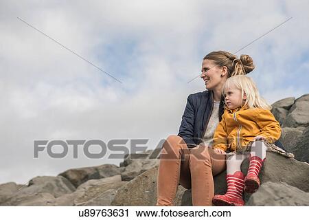 Mother and toddler sitting on harbor wall View Large Photo Image Stock Image - Mother and toddler sitting on harbor wall. Fotosearch