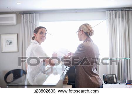Nurse and hospital receptionist View Large Photo Image Stock Image - Nurse and hospital receptionist. Fotosearch