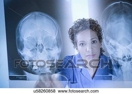 Nurse pointing at xray results displayed on screen View Large Photo Image Stock Photo - Nurse pointing at xray results displayed on screen. Fotosearch