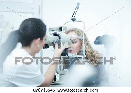 Stock Photography - Optician and patient in eye clinic. Fotosearch