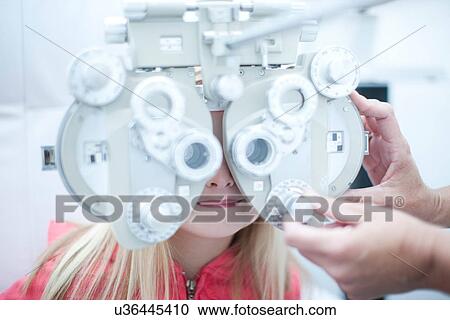 Optician testing young girl in eye clinic View Large Photo Image Stock Image - Optician testing young girl in eye clinic. Fotosearch