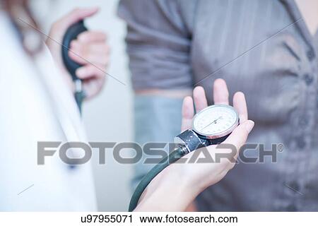 Stock Image - Patient having blood pressure taken. Fotosearch