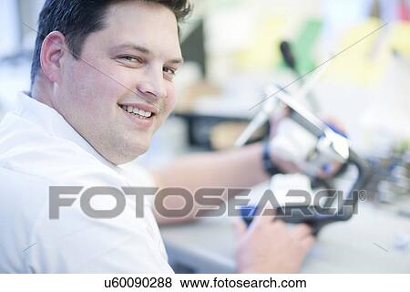Portrait of dental technician working in lab View Large Photo Image Stock Photo - Portrait of dental technician working in lab. Fotosearch