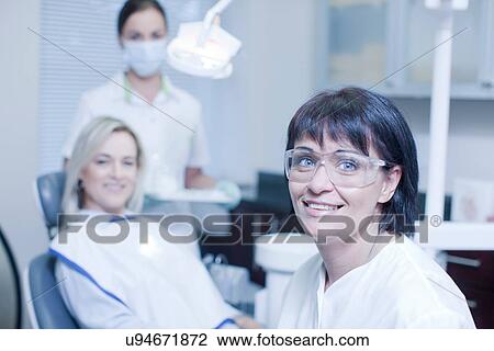 Portrait of dentist with nurse and patient View Large Photo Image Stock Image - Portrait of dentist with nurse and patient. Fotosearch