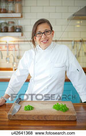 Stock Photo - Portrait of female chef in commercial kitchen. Fotosearch