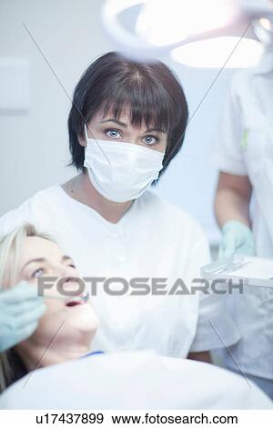 Stock Photo - Portrait of female dentist ready to treat female patient. Fotosearch