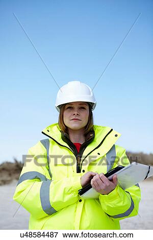 Portrait of female outdoors holding file and digital tablet View Large Photo Image Stock Photo - Portrait of female outdoors holding file and digital tablet. Fotosearch