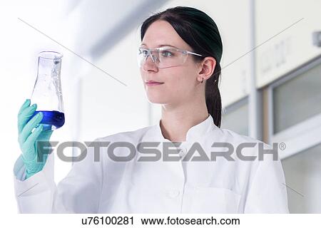 Portrait of female scientist examining glass container View Large Photo Image Stock Image - Portrait of female scientist examining glass container. Fotosearch
