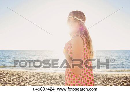 Picture - Portrait of girl on beach looking back. Fotosearch