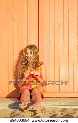Portrait of girl sitting on beach hut step View Large Photo Image Picture - Portrait of girl sitting on beach hut step. Fotosearch