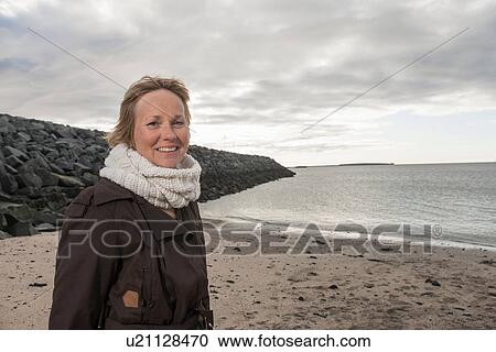 Portrait of mature woman at coast View Large Photo Image Stock Image - Portrait of mature woman at coast. Fotosearch