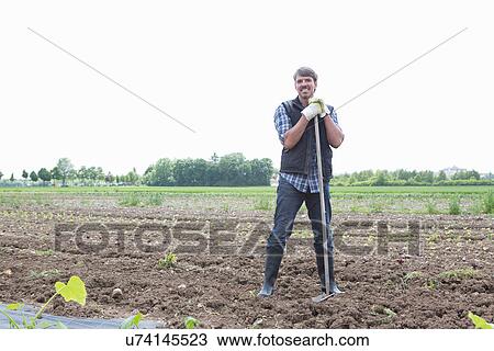 Portrait of organic farmer with rake View Large Photo Image Stock Image - Portrait of organic farmer with rake. Fotosearch