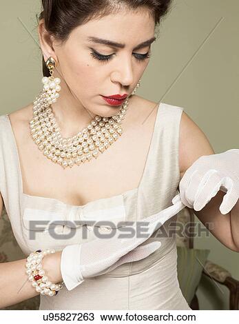 Portrait of woman in vintage clothes removing glove View Large Photo Image Stock Image - Portrait of woman in vintage clothes removing glove. Fotosearch
