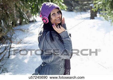 Portrait of young female listening to headphones View Large Photo Image Stock Image - Portrait of young female listening to headphones. Fotosearch