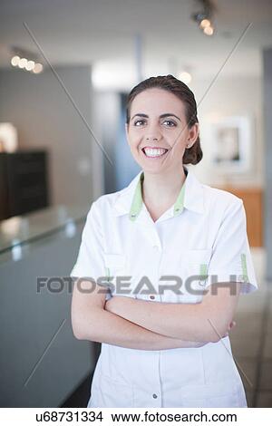 Portrait of young female nurse standing in reception View Large Photo Image Picture - Portrait of young female nurse standing in reception. Fotosearch