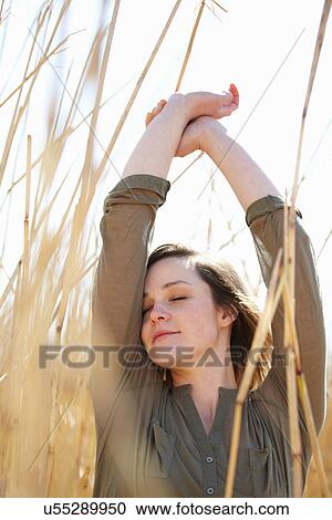 Portrait of young woman amongst reeds View Large Photo Image Stock Image - Portrait of young woman amongst reeds. Fotosearch
