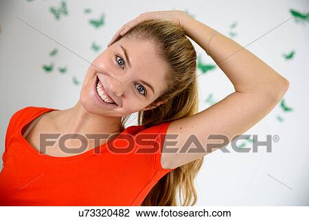 Stock Image - Portrait of young woman exercising at home. Fotosearch