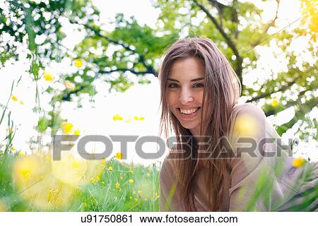 Portrait of young woman in field of buttercups View Large Photo Image Stock Image - Portrait of young woman in field of buttercups. Fotosearch