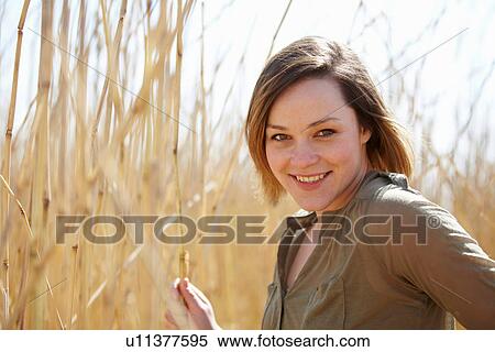 Portrait of young woman in front of reeds View Large Photo Image Stock Photography - Portrait of young woman in front of reeds. Fotosearch