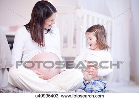 Pregnant mother and young daughter comparing bumps View Large Photo Image Stock Image - Pregnant mother and young daughter comparing bumps. Fotosearch