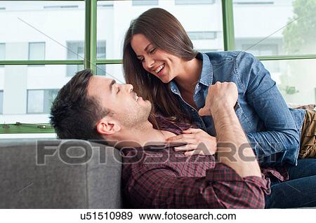 Stock Photo - Romantic young couple at home fooling about. Fotosearch