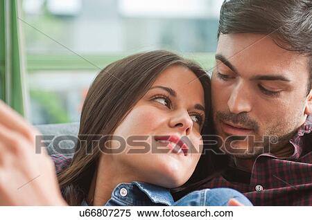 Romantic young couple lounging on sofa View Large Photo Image Stock Photography - Romantic young couple lounging on sofa. Fotosearch