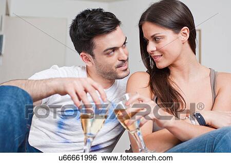 Romantic young couple sharing glass of wine View Large Photo Image Stock Photograph - Romantic young couple sharing glass of wine. Fotosearch