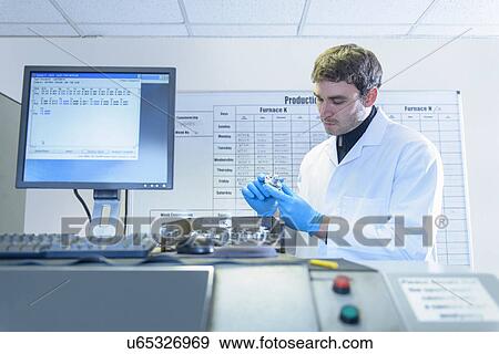 Stock Photo - Scientist checking quality of aluminum sample. Fotosearch