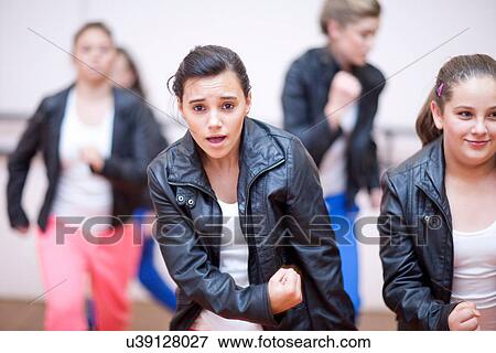 Stock Photo - Small group of teenagers practicing dance in studio. Fotosearch