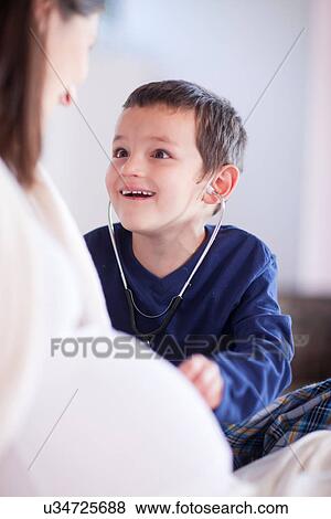 Son using stethoscope on mothers bump View Large Photo Image Stock Photo - Son using stethoscope on mothers bump. Fotosearch