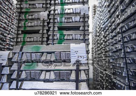 Stock Image - Stacked and stored aluminum ingots. Fotosearch