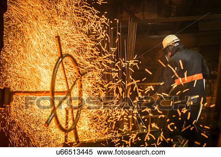Steel worker amongst sparks in steel foundry View Large Photo Image Stock Photography - Steel worker amongst sparks in steel foundry. Fotosearch