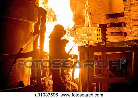 Steel worker in front of furnace fire in steel foundry View Large Photo Image Stock Photograph - Steel worker in front of furnace fire in steel foundry. Fotosearch