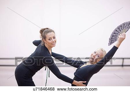 Stock Photo - Teacher adjusting ballerinas pose. Fotosearch