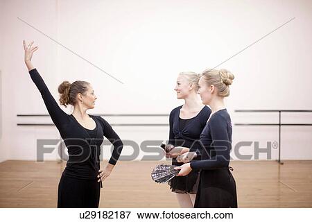 Teacher demonstrating pose to ballerinas View Large Photo Image Stock Photo - Teacher demonstrating pose to ballerinas. Fotosearch