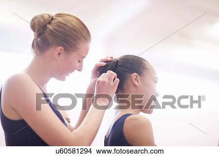 Teenage ballerina helping friend with hair View Large Photo Image Picture - Teenage ballerina helping friend with hair. Fotosearch