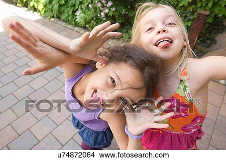 Two girls pulling faces View Large Photo Image Picture - Two girls pulling faces. Fotosearch